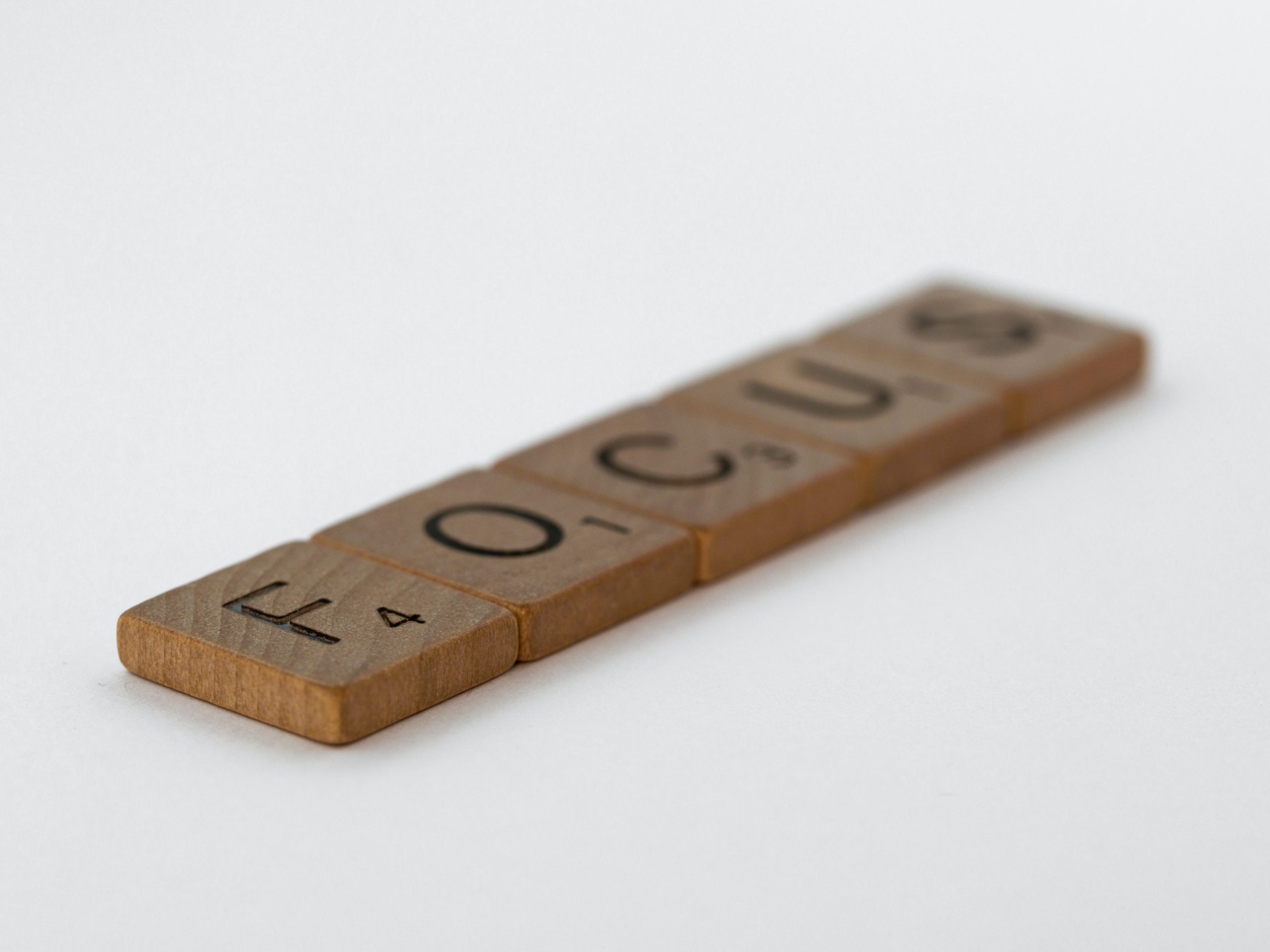 wooden scrabble letters spelling focus
